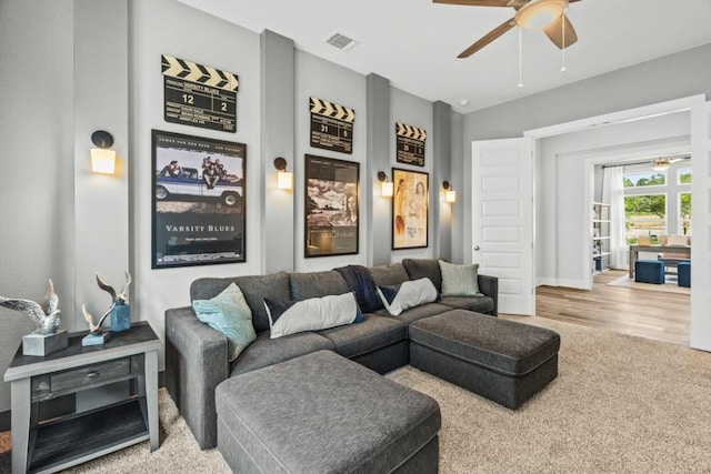 237 San Xavier St, Georgetown, TX 78633 - carpeted living area featuring a ceiling fan, baseboards, and wood finished floors