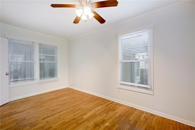 unfurnished room featuring a ceiling fan, baseboards, ornamental molding, and wood finished floors
