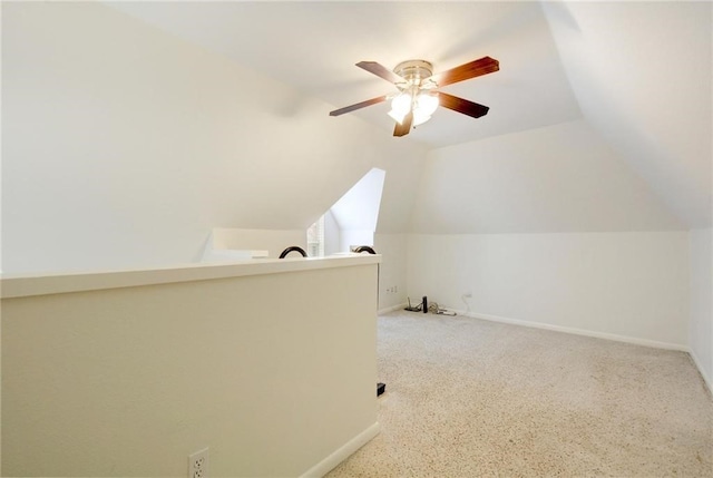 additional living space with lofted ceiling, baseboards, and ceiling fan