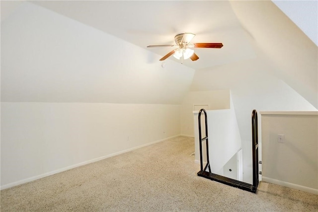 additional living space with ceiling fan, vaulted ceiling, carpet flooring, and baseboards