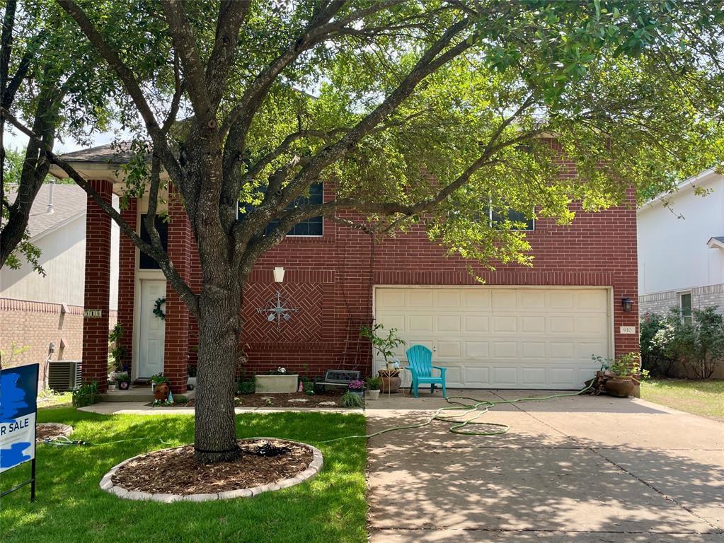 910 Moser River Dr, Leander, TX 78641 - view of front facade with brick siding, concrete driveway, and a garage