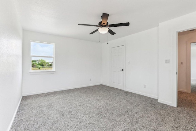 carpeted empty room with baseboards and ceiling fan