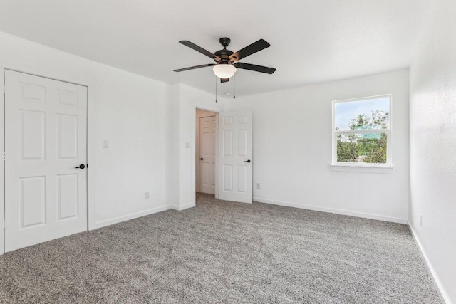 unfurnished bedroom with carpet floors, baseboards, and ceiling fan