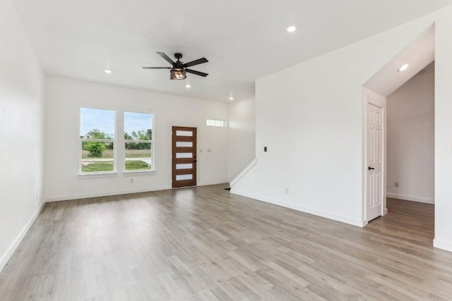 unfurnished living room featuring light wood finished floors, baseboards, recessed lighting, and ceiling fan