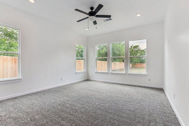 empty room with visible vents, a ceiling fan, baseboards, and carpet
