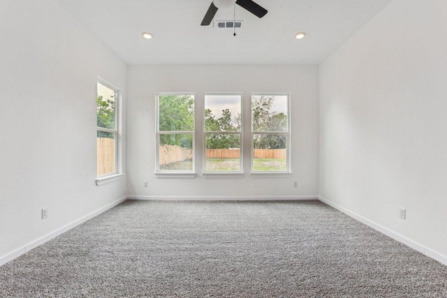 carpeted empty room with baseboards, visible vents, recessed lighting, and ceiling fan
