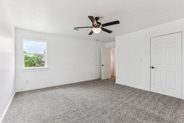 unfurnished bedroom featuring baseboards, a ceiling fan, visible vents, and carpet