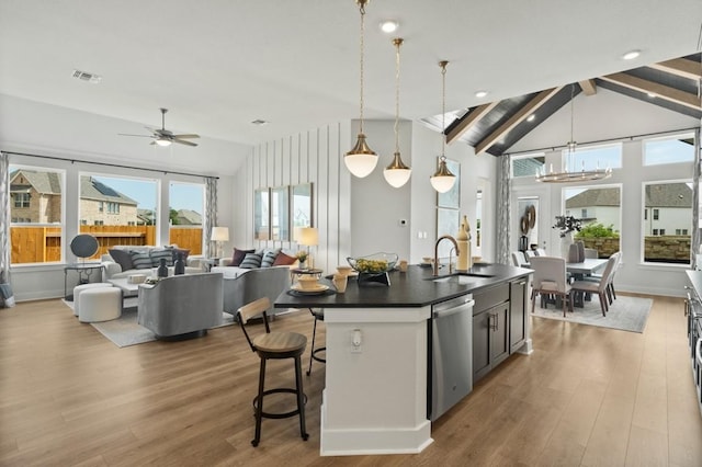 2104 Tobiano Trce, Georgetown, TX 78633 - kitchen featuring stainless steel dishwasher, dark countertops, plenty of natural light, and wood finished floors