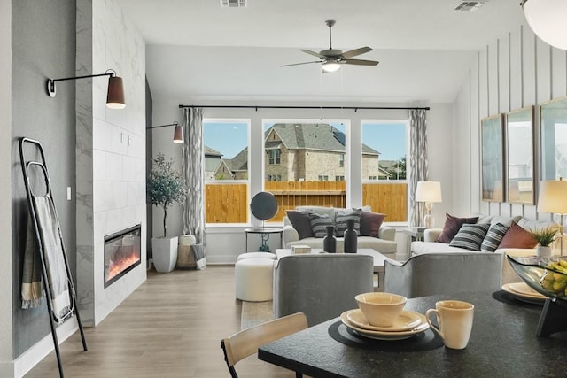 2104 Tobiano Trce, Georgetown, TX 78633 - living area featuring wood finished floors, a ceiling fan, and a tile fireplace