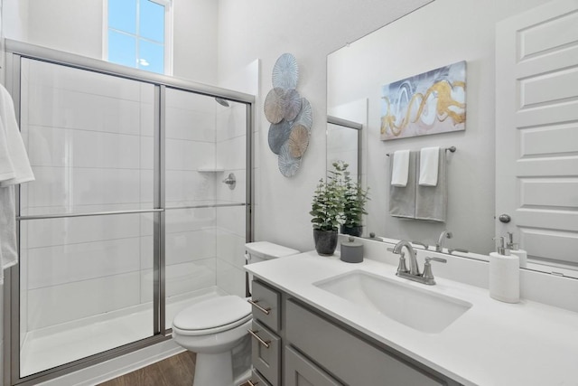 2104 Tobiano Trce, Georgetown, TX 78633 - full bath with vanity, a shower stall, and wood finished floors