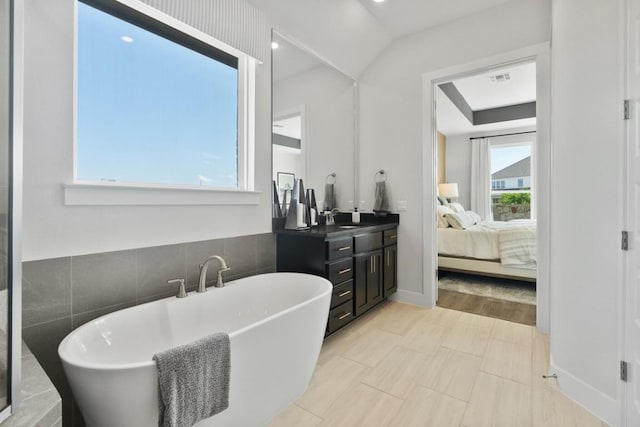 2104 Tobiano Trce, Georgetown, TX 78633 - full bathroom with a soaking tub, ensuite bathroom, vanity, and tile walls