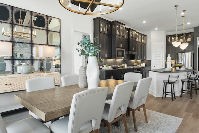 2104 Tobiano Trce, Georgetown, TX 78633 - dining room featuring a chandelier, wood finished floors, and recessed lighting