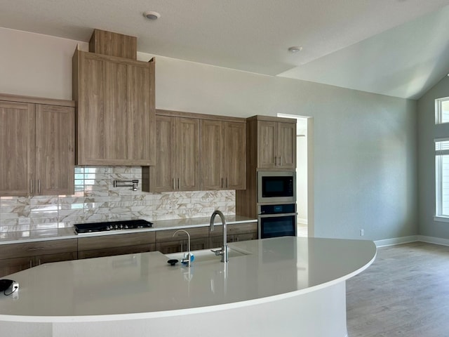 2104 Tobiano Trce, Georgetown, TX 78633 - kitchen with stainless steel appliances, light countertops, decorative backsplash, and healthy amount of natural light
