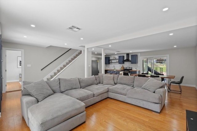 3400 Santa Fe Dr, Austin, TX 78741 - living room featuring light wood-style flooring, stairs, and recessed lighting