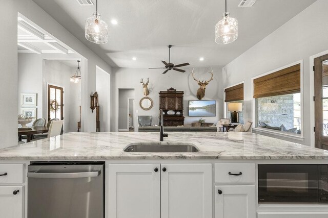 kitchen featuring white cabinets, dishwasher, a sink, a wealth of natural light, and open floor plan