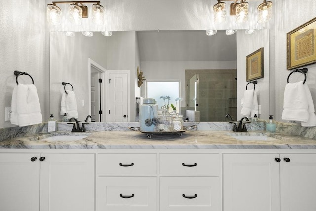 full bath featuring a sink, a shower stall, and double vanity