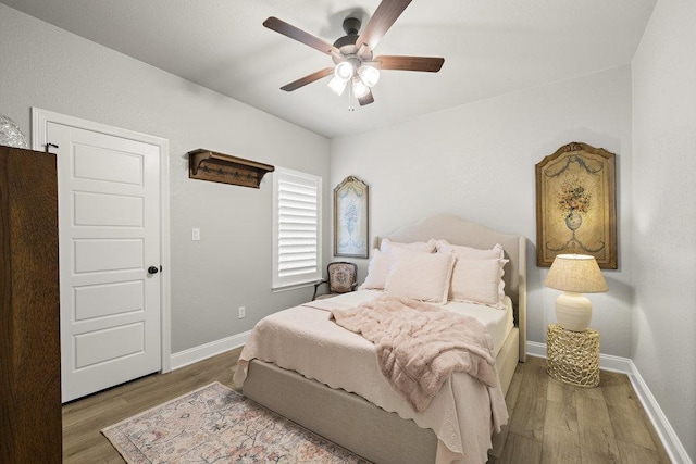 bedroom featuring baseboards, a ceiling fan, and wood finished floors