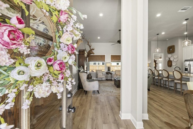interior space with recessed lighting, wood finished floors, visible vents, and decorative columns