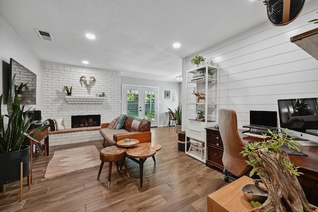1213 S Trace Dr, Austin, TX 78745 - home office featuring french doors, visible vents, recessed lighting, wood finished floors, and a fireplace