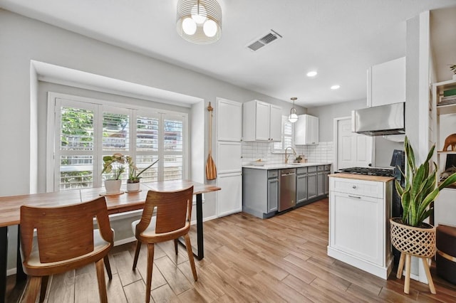 1213 S Trace Dr, Austin, TX 78745 - kitchen featuring range hood, gray cabinets, light wood-type flooring, plenty of natural light, and recessed lighting