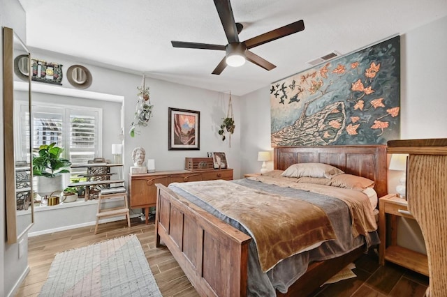 1213 S Trace Dr, Austin, TX 78745 - bedroom with ceiling fan, light wood finished floors, and visible vents