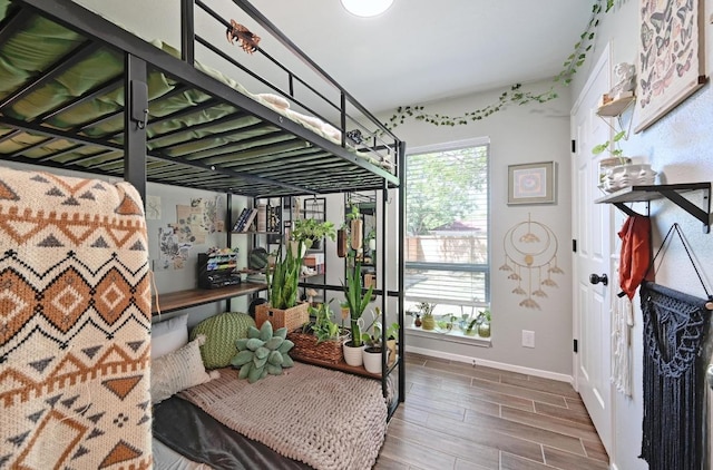 1213 S Trace Dr, Austin, TX 78745 - bedroom featuring wood finished floors and baseboards
