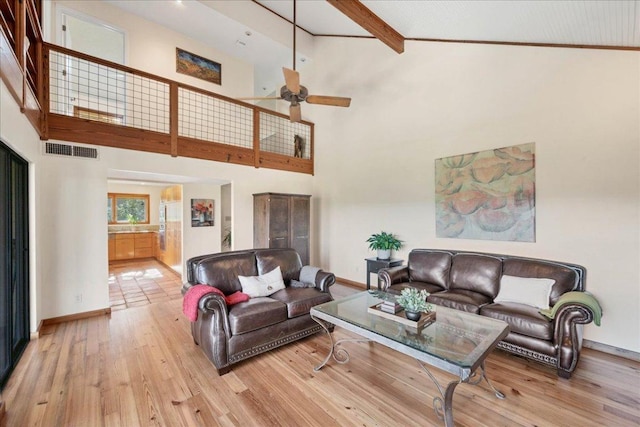 8509 Appalachian Dr, Austin, TX 78759 - living area featuring a high ceiling, a ceiling fan, light wood-type flooring, and beam ceiling