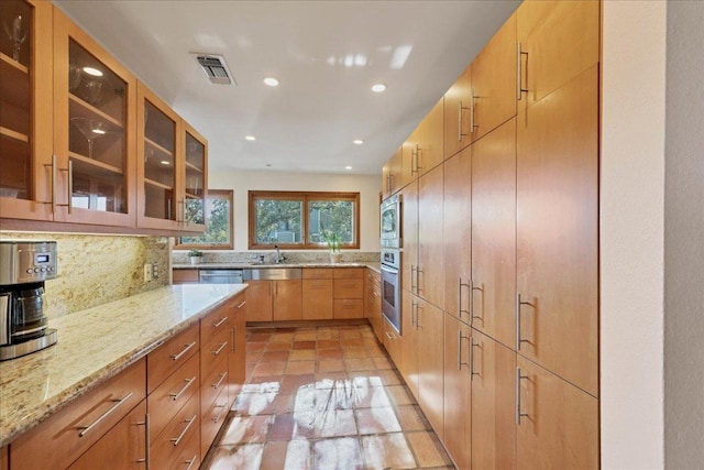 kitchen featuring tasteful backsplash, visible vents, recessed lighting, light stone counters, and appliances with stainless steel finishes
