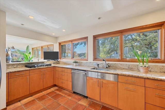 kitchen with gas cooktop, a sink, recessed lighting, light stone countertops, and dishwasher