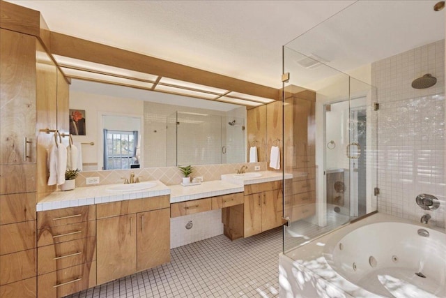 8509 Appalachian Dr, Austin, TX 78759 - bathroom with a stall shower, double vanity, a jetted tub, tasteful backsplash, and tile patterned floors