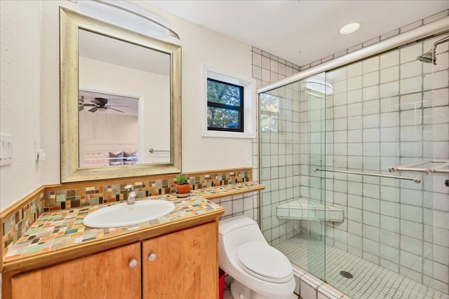 8509 Appalachian Dr, Austin, TX 78759 - bathroom with vanity, a shower stall, a ceiling fan, and decorative backsplash
