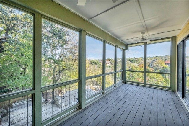 unfurnished sunroom featuring a ceiling fan