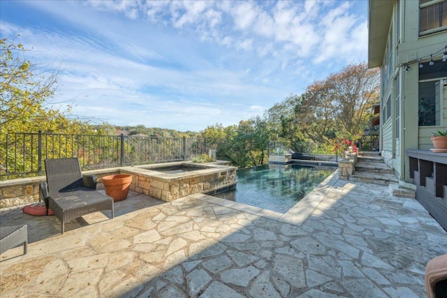 view of swimming pool with a fenced in pool, a patio, and an in ground hot tub