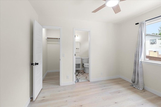 6007 Wideleaf Dr, Austin, TX 78724 - unfurnished bedroom featuring wood finished floors, ensuite bath, a closet, baseboards, and a spacious closet