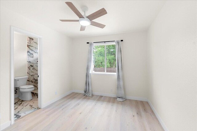 6007 Wideleaf Dr, Austin, TX 78724 - unfurnished bedroom featuring baseboards, wood finished floors, a ceiling fan, and ensuite bath