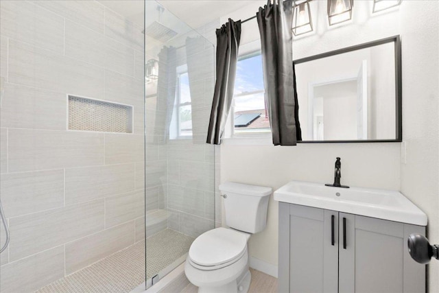 6007 Wideleaf Dr, Austin, TX 78724 - full bathroom with baseboards, a walk in shower, toilet, and vanity