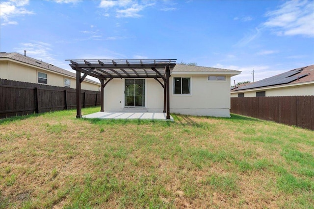 6007 Wideleaf Dr, Austin, TX 78724 - rear view of house with a pergola, a patio area, a yard, a fenced backyard, and stucco siding