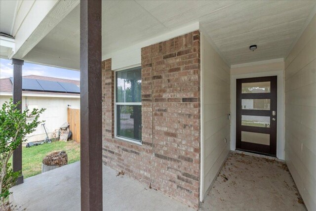 6007 Wideleaf Dr, Austin, TX 78724 - doorway to property featuring a patio and brick siding