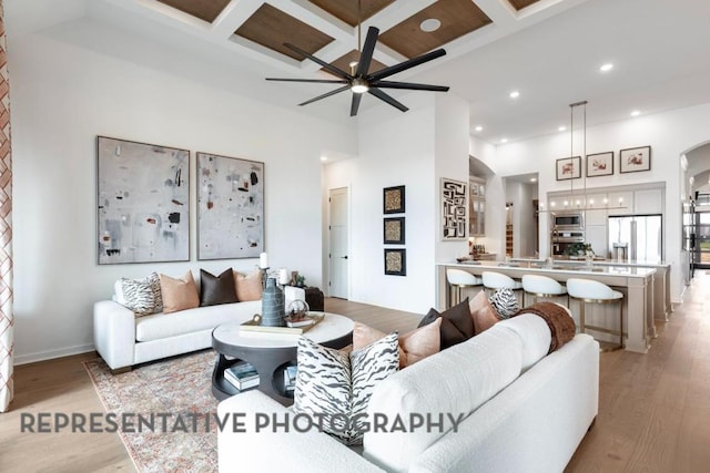 1708 Snowdrop Dr, Georgetown, TX 78628 - living area featuring light wood-style flooring, recessed lighting, coffered ceiling, a high ceiling, and ceiling fan