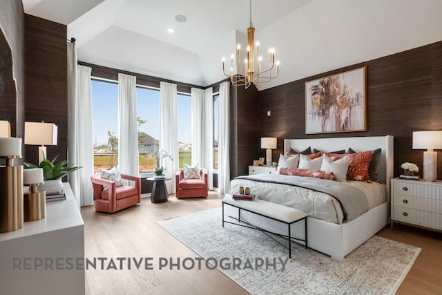 1708 Snowdrop Dr, Georgetown, TX 78628 - bedroom featuring wood finished floors, lofted ceiling, and an inviting chandelier
