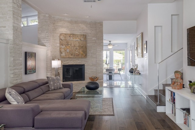 living room with stairway, a ceiling fan, dark wood-style floors, and plenty of natural light