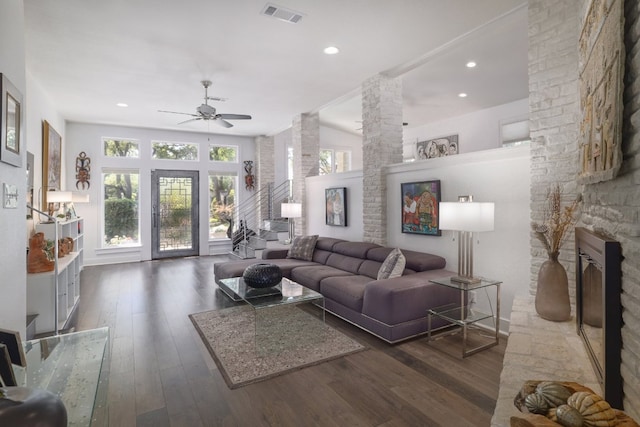 living room featuring a ceiling fan, hardwood / wood-style floors, visible vents, and plenty of natural light