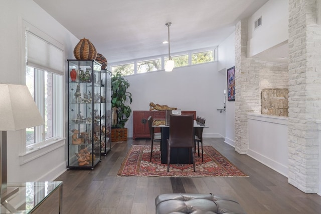 dining area featuring plenty of natural light, visible vents, and dark wood-style flooring