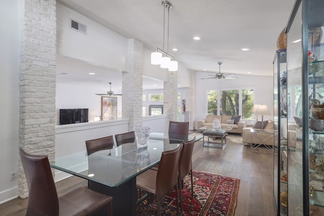dining area with ceiling fan, wood finished floors, visible vents, and ornate columns