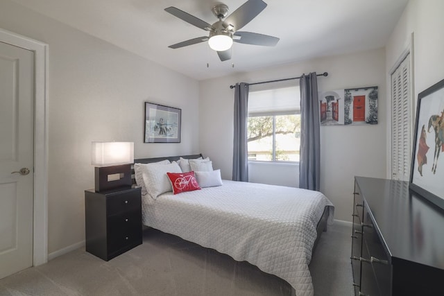 carpeted bedroom with ceiling fan, baseboards, and a closet