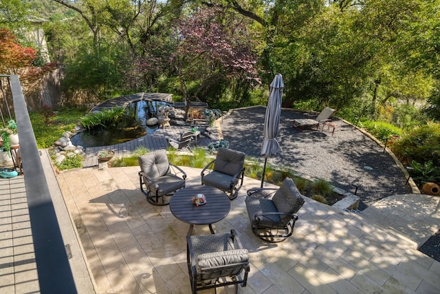 view of patio / terrace with an outdoor living space and a small pond
