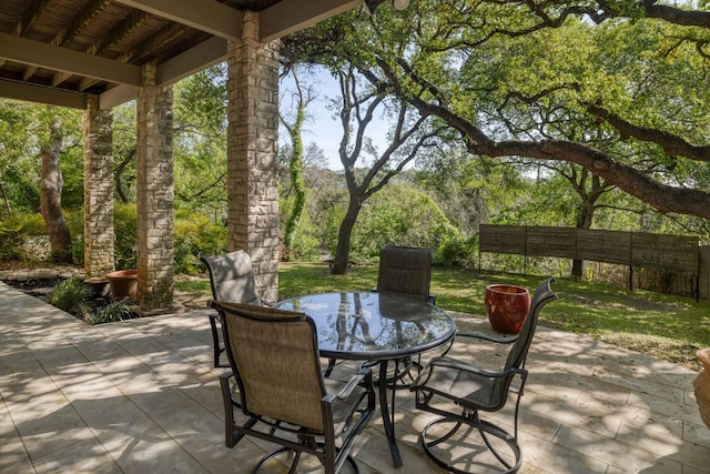 view of patio with outdoor dining area and fence