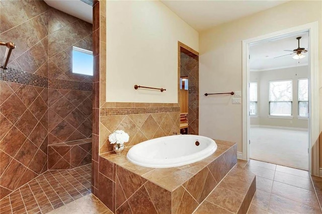 bathroom with tile patterned flooring, walk in shower, a wealth of natural light, and a garden tub