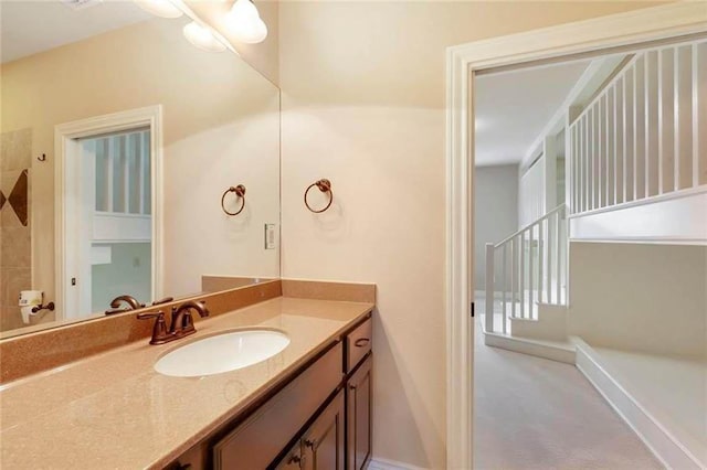 full bath featuring vanity and tiled shower