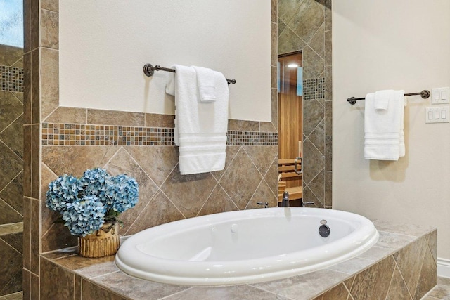 190 Estrella Xing, Georgetown, TX 78628 - full bathroom featuring a garden tub and tile walls